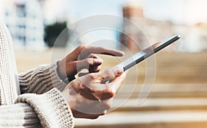 Hipster girl using tablet technology internet, girl person holding computer on background sun city, female hands texting online