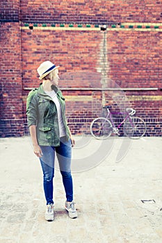 Hipster girl and vintage road bike in city