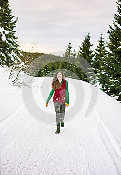 Hipster girl walking on the snowy mountain