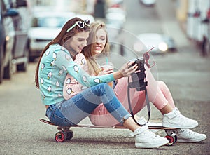 Hipster girlfriends taking a selfie in urban city