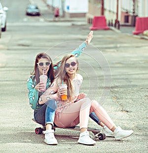 Hipster girlfriends taking a selfie in urban city