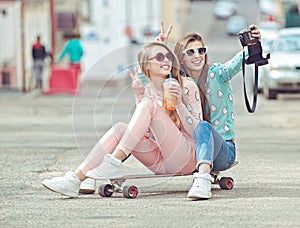 Hipster girlfriends taking a selfie in urban city