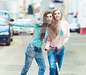 Hipster girlfriends taking a selfie in urban city