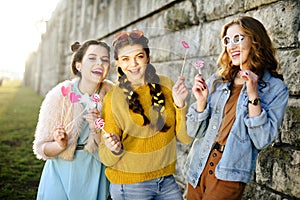 Hipster girls, colored dressed, with sunglasses and wrist watch. Grup of three girls with funny lips, glasses, stars, paper hearts