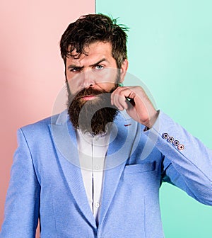 Hipster handsome attractive guy with long beard. Man bearded hipster twisting mustache pink blue background. Ultimate