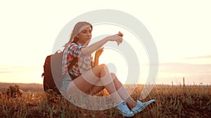 Hipster hiker silhouette girl traveler rest rest slow motion video with backpack. student doing take selfie self