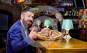 Hipster hungry eat italian pizza. Hipster client sit at bar counter. Man received delicious pizza. Enjoy your meal