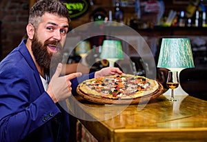 Hipster hungry eat italian pizza. Pizza favorite restaurant food. Fresh hot pizza for dinner. Hipster client sit at bar