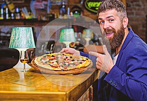 Hipster hungry eat italian pizza. Pizza favorite restaurant food. Fresh hot pizza for dinner. Hipster client sit at bar