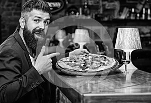 Hipster hungry eat italian pizza. Pizza favorite restaurant food. Fresh hot pizza for dinner. Hipster client sit at bar