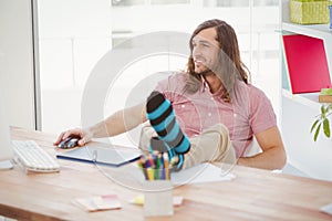 Hipster with legs on desk