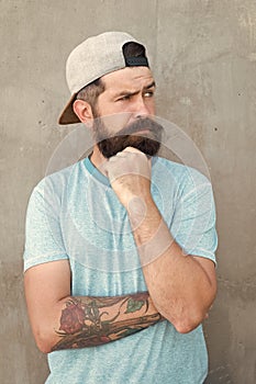 Hipster lifestyle. Brutal handsome mature hipster tattooed man. Bearded man trendy style. Beard and mustache grooming
