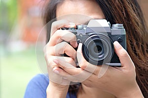 Hipster lifestyle of cute girl She holds a camera. And save photos On a digital camera.Travel and Lifestyle concept