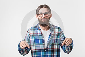 Hipster, lifestyle and people concept - Young hipster man point down on white background with copy space