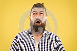 Hipster lifestyle. Surprised hipster with thick beard hair looking up. Brutal hipster man keeping mouth open with