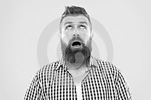 Hipster lifestyle. Surprised hipster with thick beard hair looking up. Brutal hipster man keeping mouth open with