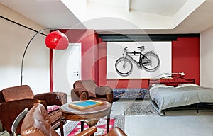 Hipster loft bedroom with bike on wall on wall