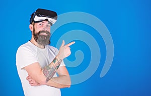 Hipster with long beard enjoying cyber space gaming, virtual reality concept. Cool man with trendy beard and confident
