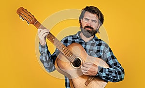 hipster with long hair and moustache sing a song. male guitarist with acoustic guitar. music concept. bearded man in