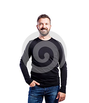 Hipster man in black long-sleeved t-shirt, studio shot, isolated