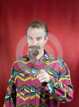 Hipster man confident showing approbation and pointing with finger at camera