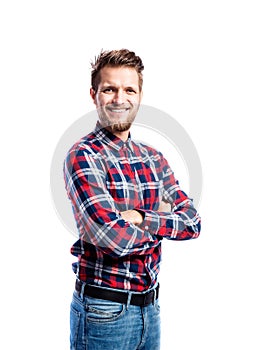 Hipster man in jeans and shirt, studio shot, isolated