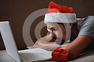 A hipster man with a red cup sitting at home at Christmas time