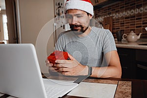 A hipster man with a red cup sitting at home at Christmas time