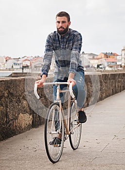 Hipster man riding in a fixie bike