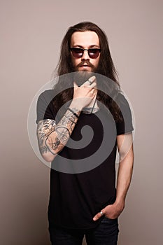 Hipster man with tattoo and sunglasses