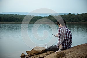 Hipster man using internet on smartphone outdoor