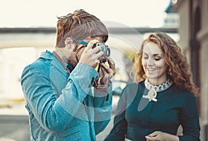 Hipster man wants to take a picture of a beautiful girl