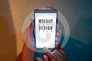 Hipster mockup image of woman`s hand holding modern mobile smartphone with blank screen for text message or advertisement content