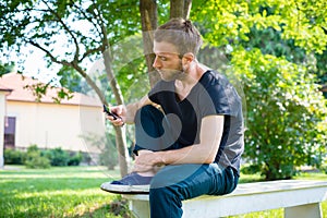 Hipster modern stylish blonde man with phone