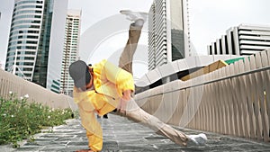 Hipster perform break dance while friend moving to music together. Sprightly.