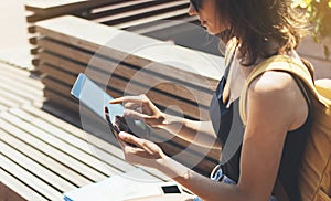 Hipster person holding in hands digital tablet with blank screen, girl photograph on computer on background nature summer park