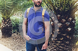 Hipster person holding in male hands digital tablet with blank screen, front view guy standing in shirt with computer