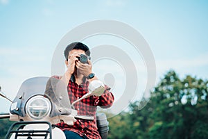 Photographer riding a motor scooter on road. Traveled by scooter slow life on vacation resting time