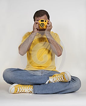 Hipster photographer in yellow clothing