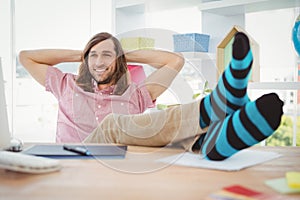 Hipster realaxing with legs on desk