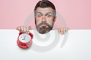 Hipster with red clock on pink background.