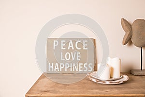 Hipster scandinavian style room interior. Mood board. Old scratched board ,Quote PEACE, LOVE, happiness. White candles