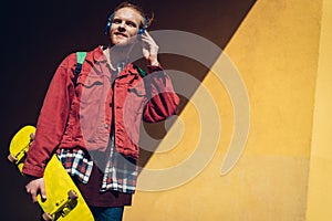 Hipster skater man listen to music via headphones