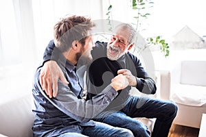 Hipster son with his senior father at home.