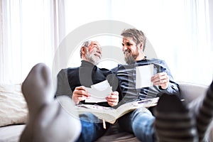 Hipster son and his senior father at home.