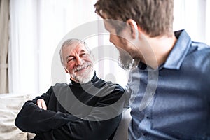 Hipster son and his senior father at home.