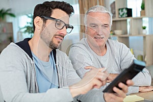 hipster son with senior father at home