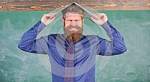 Hipster teacher aggressive with laptop as roof goes mad about teaching. Teacher bearded man with modern laptop