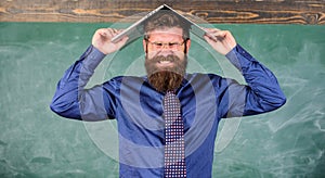 Hipster teacher aggressive with laptop as roof goes mad about teaching. Teacher bearded man with modern laptop