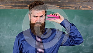 Hipster teacher formal wear with neck tie holds stapler. Back to school and studying. Teaching memorization techniques